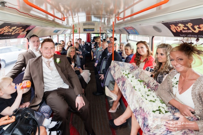 Wedding guests aboard a double-decker bus