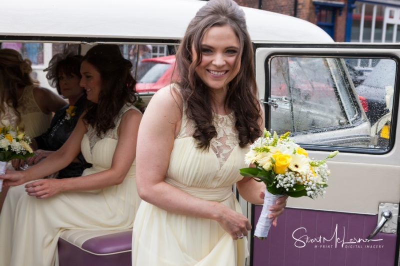 Bridesmaids with flowers outside St Mary's, Sandbach