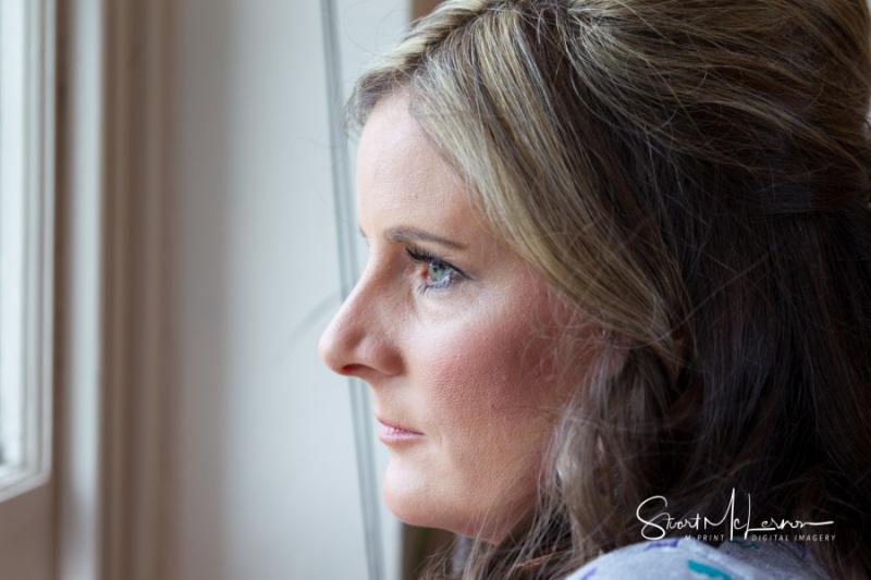 Bride looking out the window at Cranage Hall