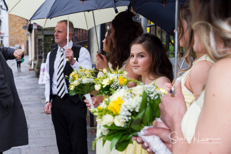 Bridesmaids waiting in the rain