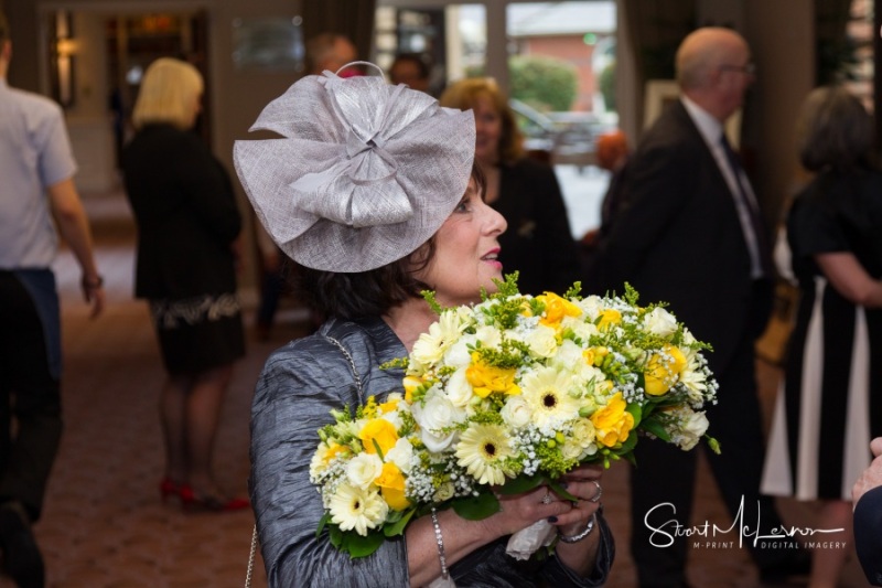 Mother of the bride holding flowers