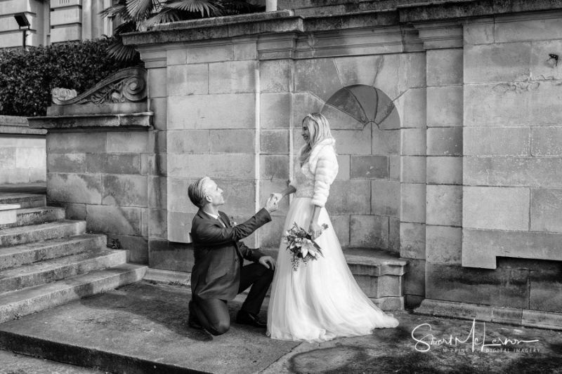 Groom on bended knee at Stockport Town Hall