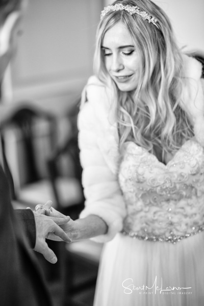 Bride places ring on finger at Stockport Town Hall