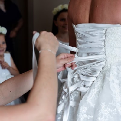 Fastening the dress Fastening the dress