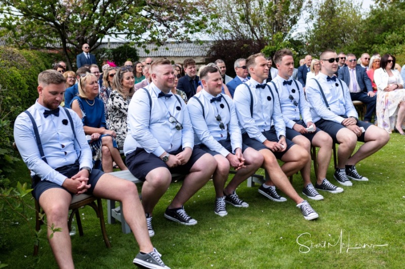 Groomsmen watching on