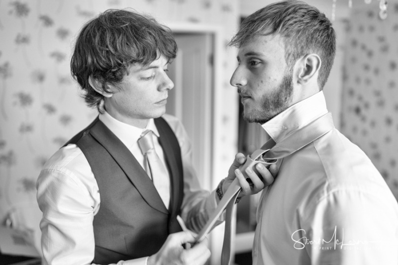 Fastening the groom's tie