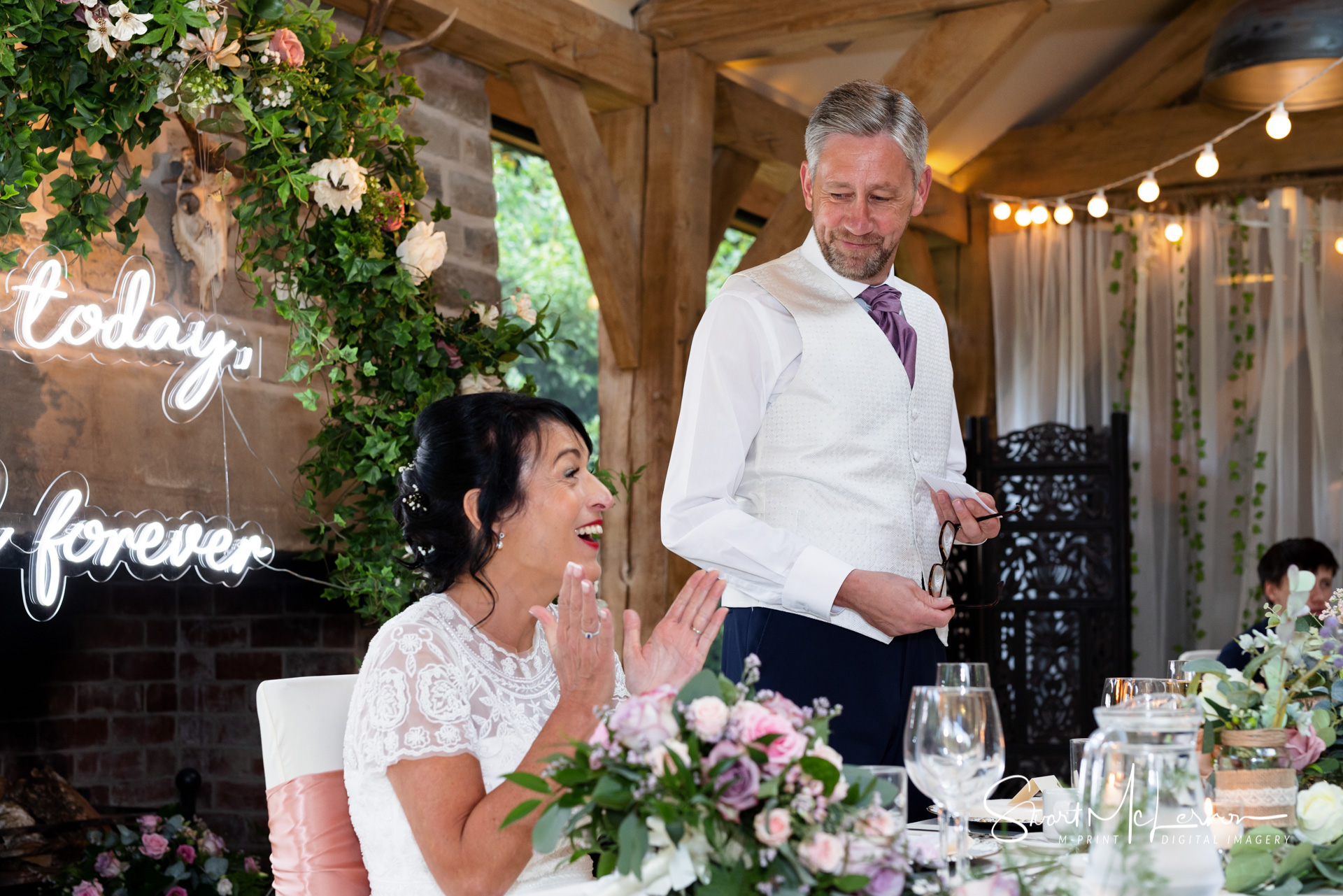 A loving moment during the wedding speech at The White Hart Inn at Lydgate