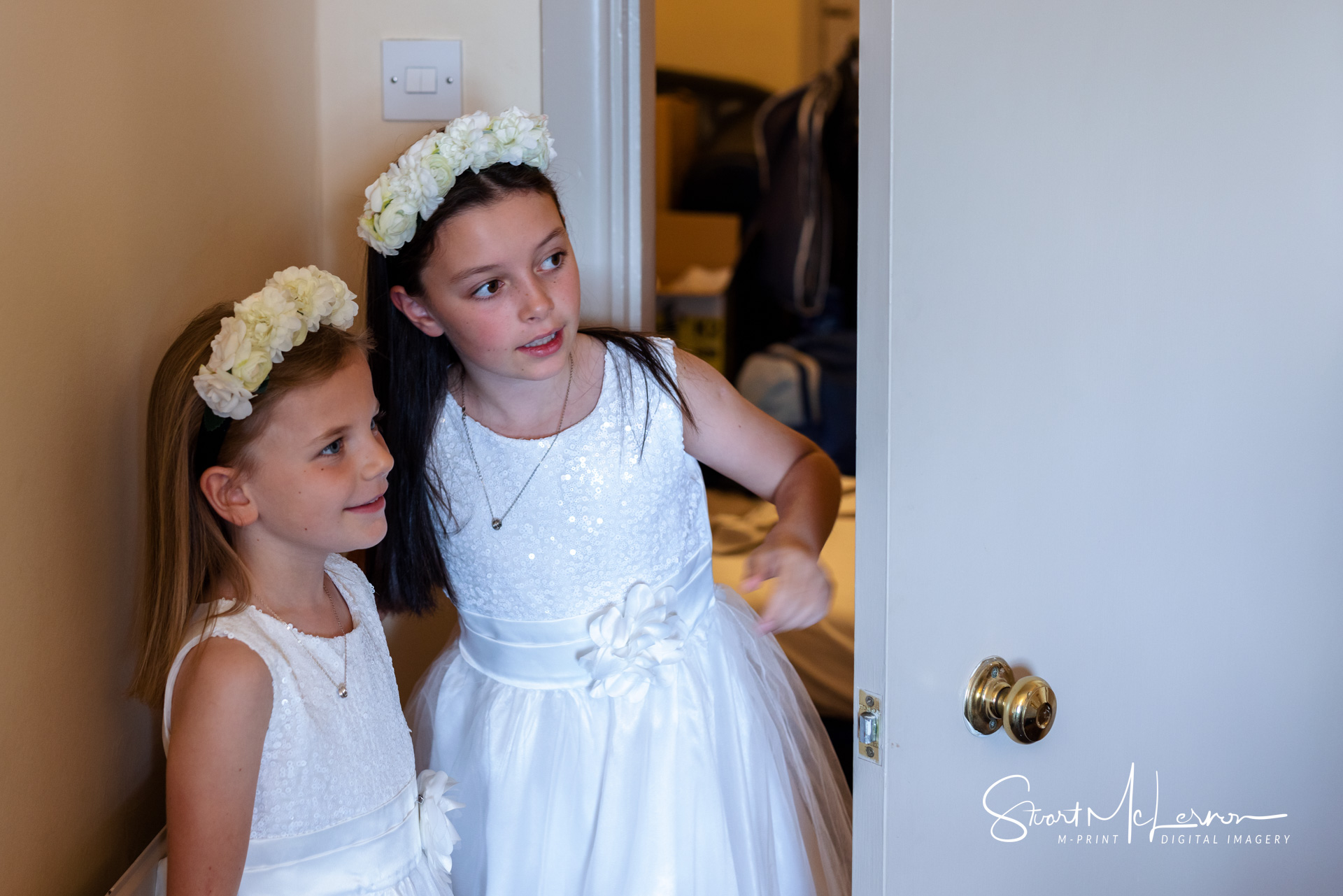 Flower girls peeking around door