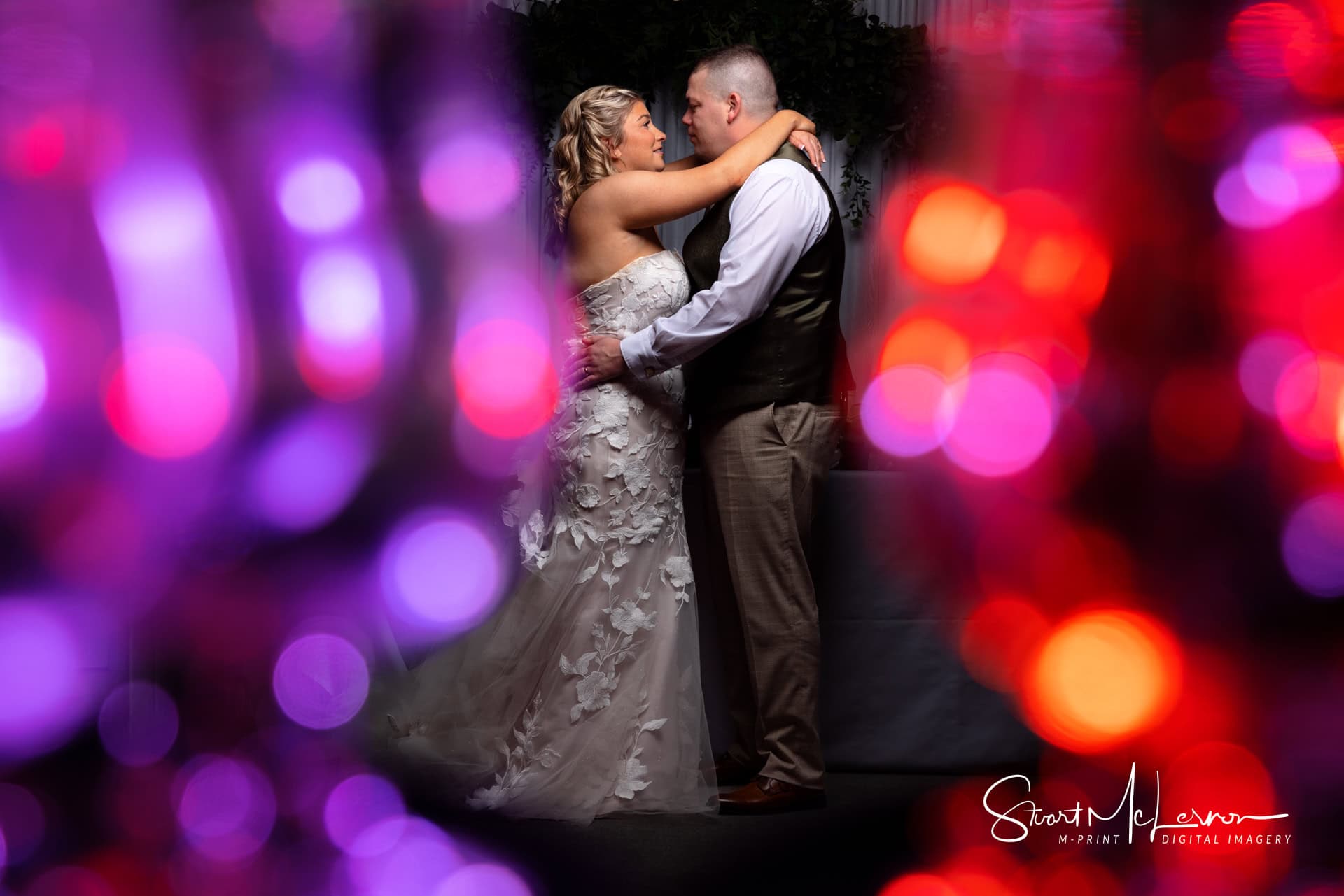 The newlyweds pose for a colourful portrait at Village Point, Heaton Moor