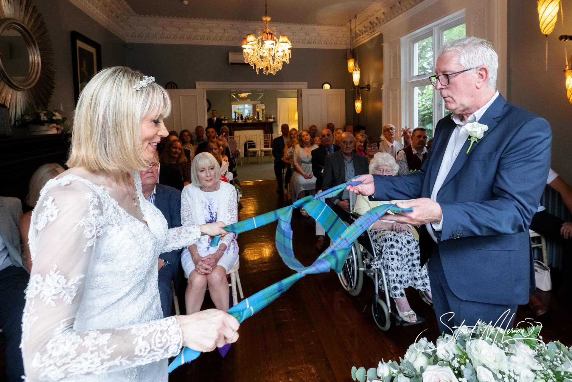 The newlyweds performing a handfasting ritual at The Didsbury House Hotel