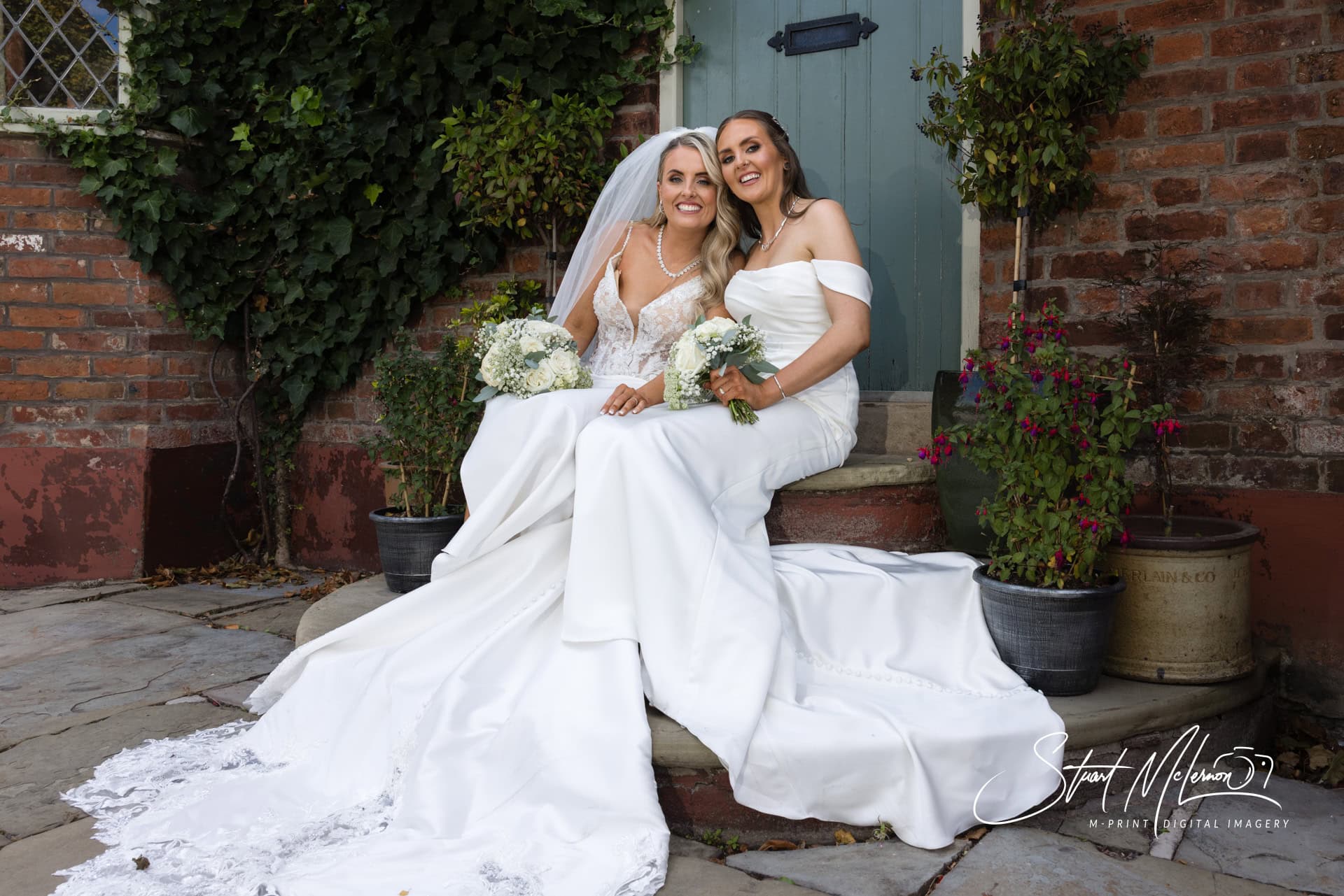 Two brides pose outside the front door of The Plough Inn at Eaton
